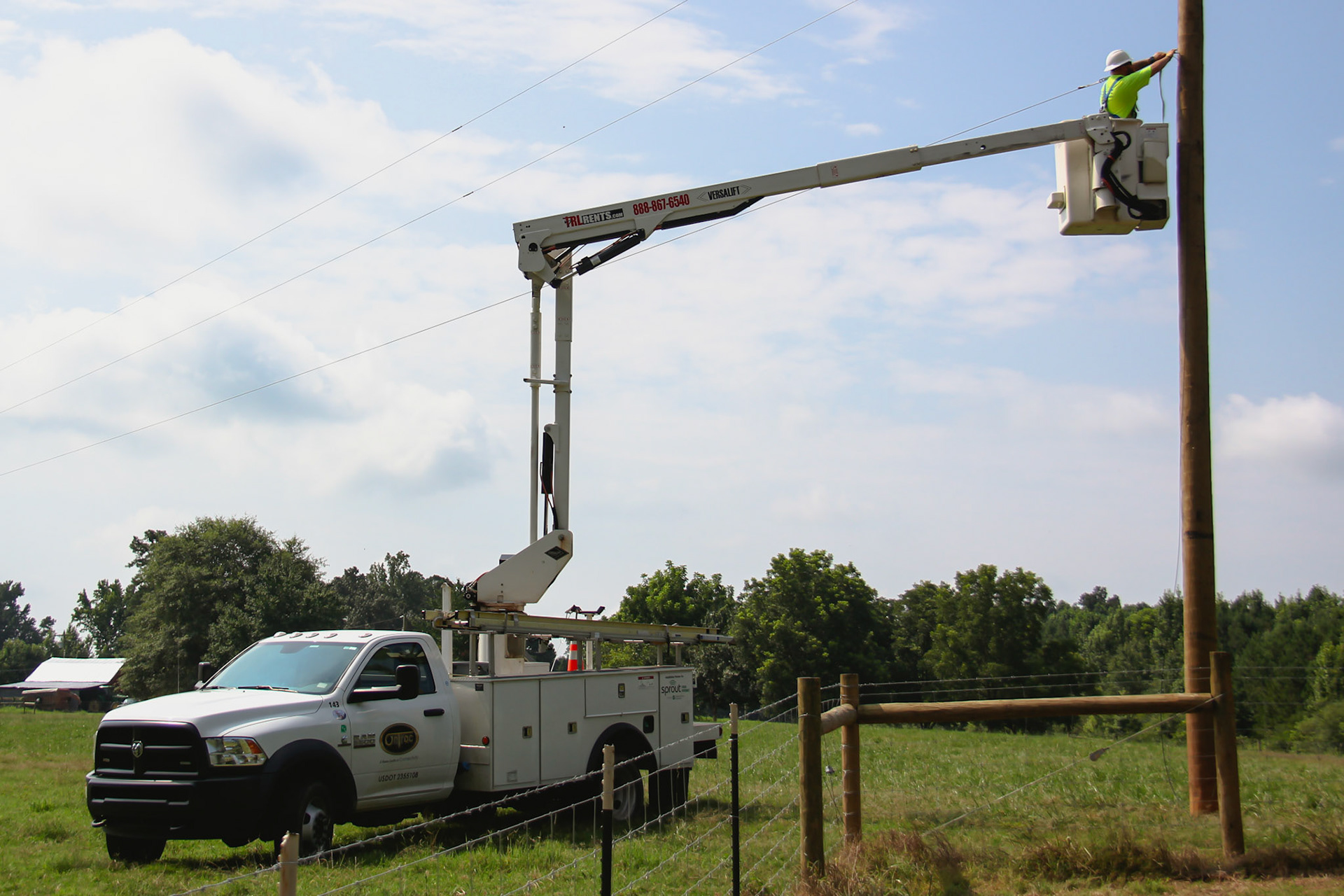 bucket truck extended and man working at pole